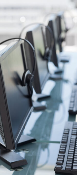 Computers and headsets from a call center in line